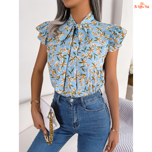 Lightweight floral chiffon blouse for women, featuring bow and ruffle details — perfect for casual summer wear with a soft and romantic look.