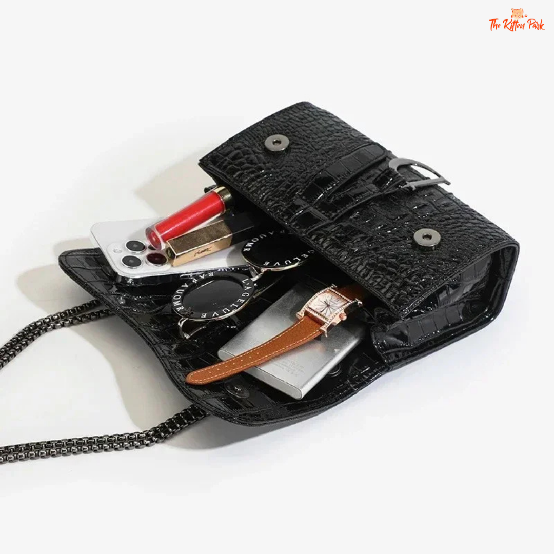 Box-shaped women's crossbody bag with sequins, animal print details, chain strap, and zippered interior for a stylish and glamorous look.