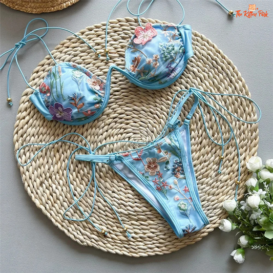 Sexy micro thong bikini with floral embroidery, red string design, low waist, and wire-free padded support for summer beachwear.