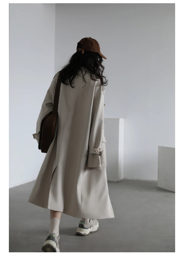 Womenβs long double-breasted trench coat with wide waist design, tiered details, and turn-down collar in solid woven fabric