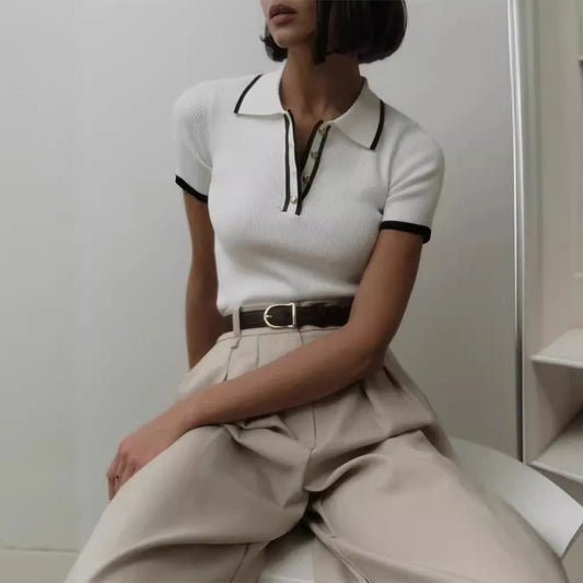 Elegant ribbed knit top with patchwork detail, short sleeves, and turn-down collar in a refined modern style.