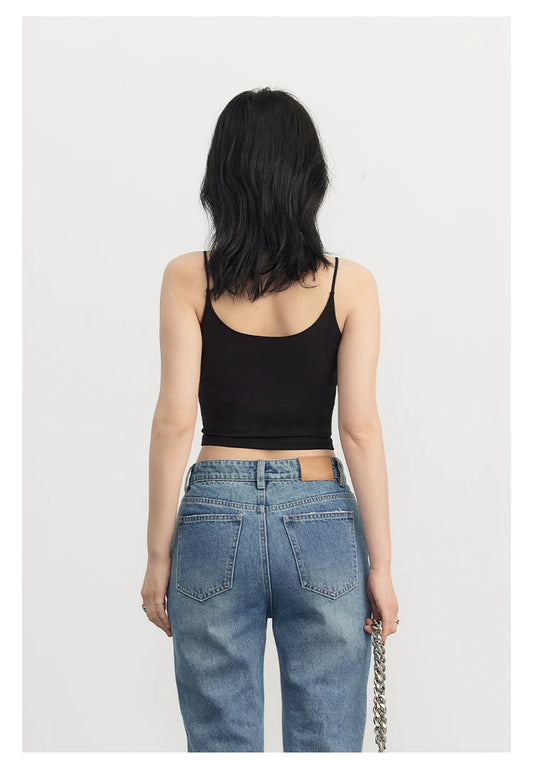 Black and white cropped cami top with solid color pattern, made from breathable stretch cotton blend, styled for summer layering.