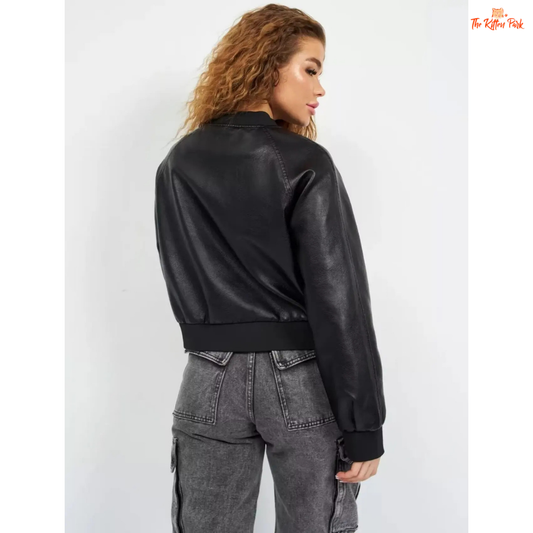 A sleek black PU leather jacket for women with a zippered front, round neck, and long sleeves, styled for modern streetwear fashion.