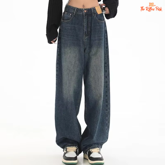 Y2K style high-waisted wide leg jeans in denim blue with button and pocket details.