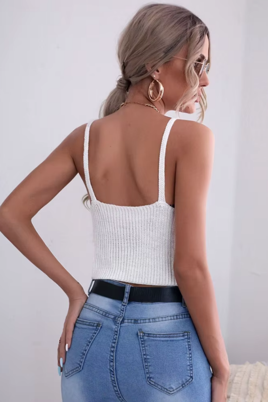 Elegant white knit camisole with V-neck and crochet detailing, styled for summer high street fashion.