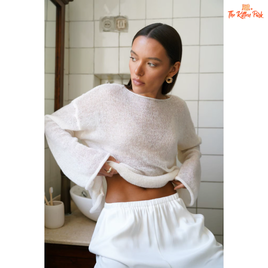 Oversized white sweater with a soft, cozy knit—perfect for breezy summer nights and crisp autumn mornings.