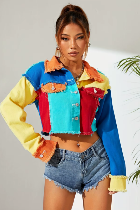Colorblock denim coat with raw hem and patchwork design in vibrant shades of red, turquoise, yellow, and blue.