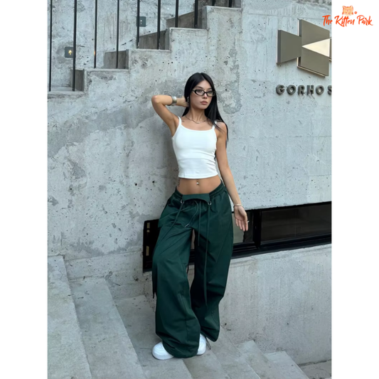 Y2K black cargo joggers for women with lace-up details, high elastic waist, and functional pockets in a dark green and black colorway.