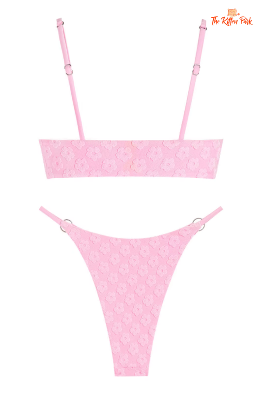Soft pink floral jacquard bikini set with O-ring detail, terry cloth fabric, triangle cups, and wire-free mid waist design.