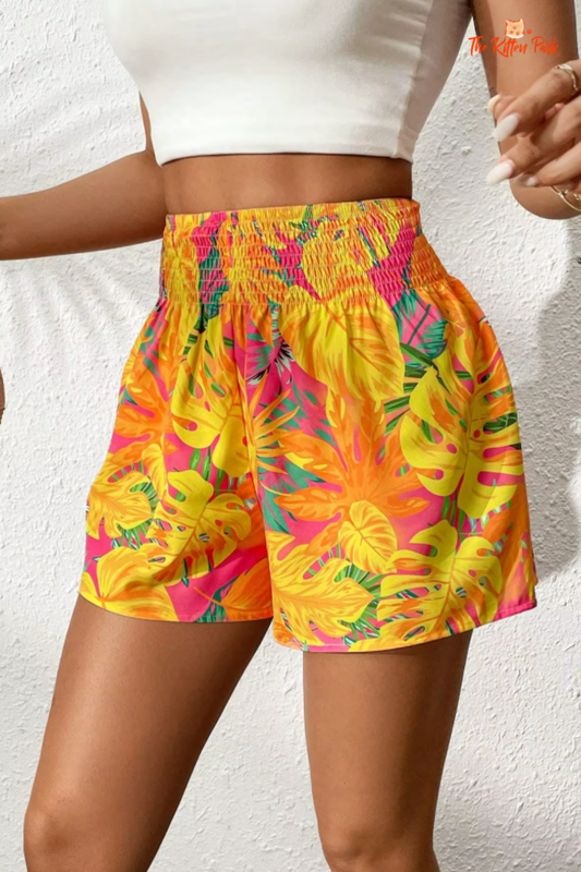 Women's tropical floral print shirt and mid-waist shorts set in pink, red, yellow tones, perfect for beach style and summer vacations.