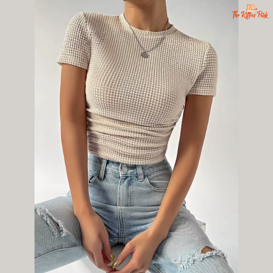 Short sleeve slim-fit beige crop tee with hollow-out detail, made for casual summer styling.