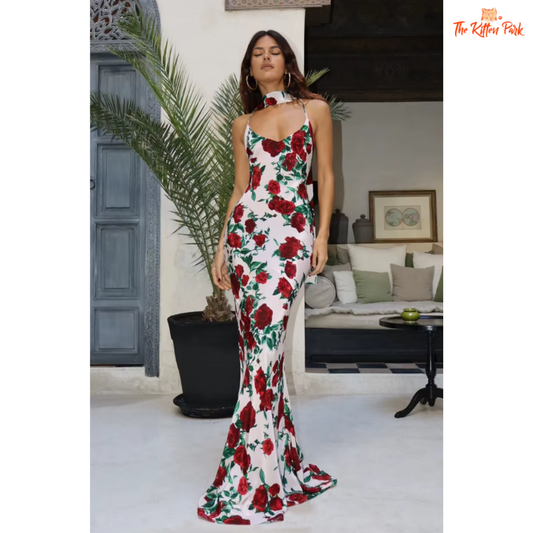 Elegant printed backless halter maxi dress with spaghetti straps, perfect for evening parties and summer events. Features a natural waistline and floor-length silhouette.