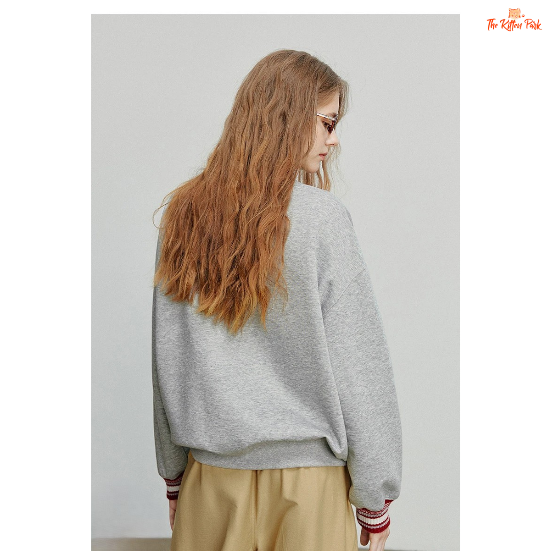 2026 Women's Cat Embroidery Striped Sleeve Cotton Pullover with cute cat embroidery, striped sleeves, and loose casual autumn style.