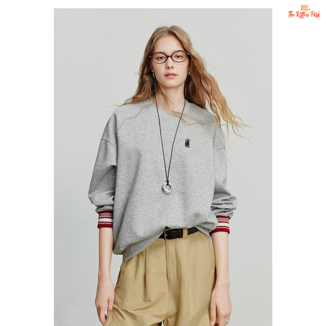 2026 Women's Cat Embroidery Striped Sleeve Cotton Pullover with cute cat embroidery, striped sleeves, and loose casual autumn style.