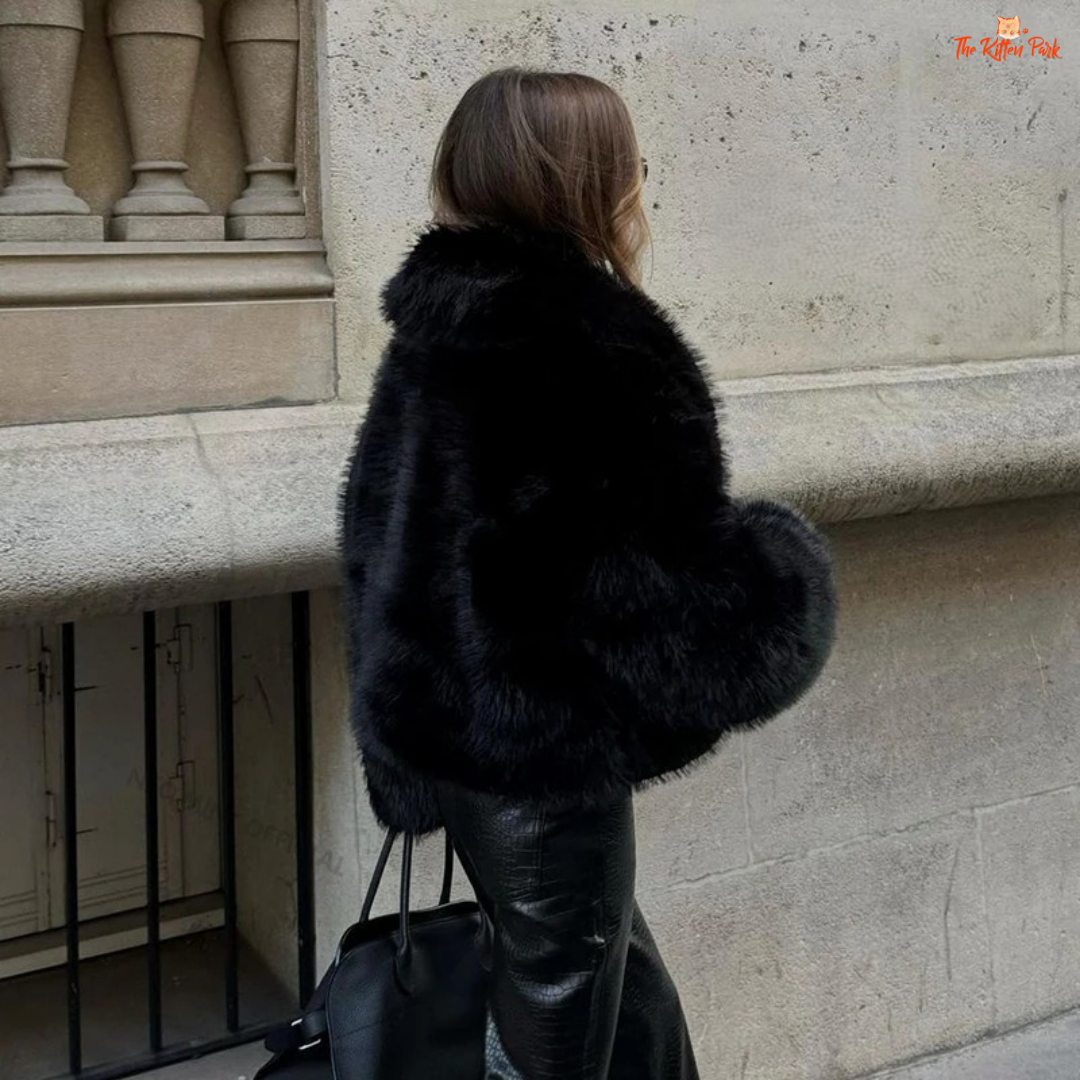 A black faux fox fur coat for women with a shawl collar, batwing sleeves, and short streetwear cut for warm and stylish winter fashion.