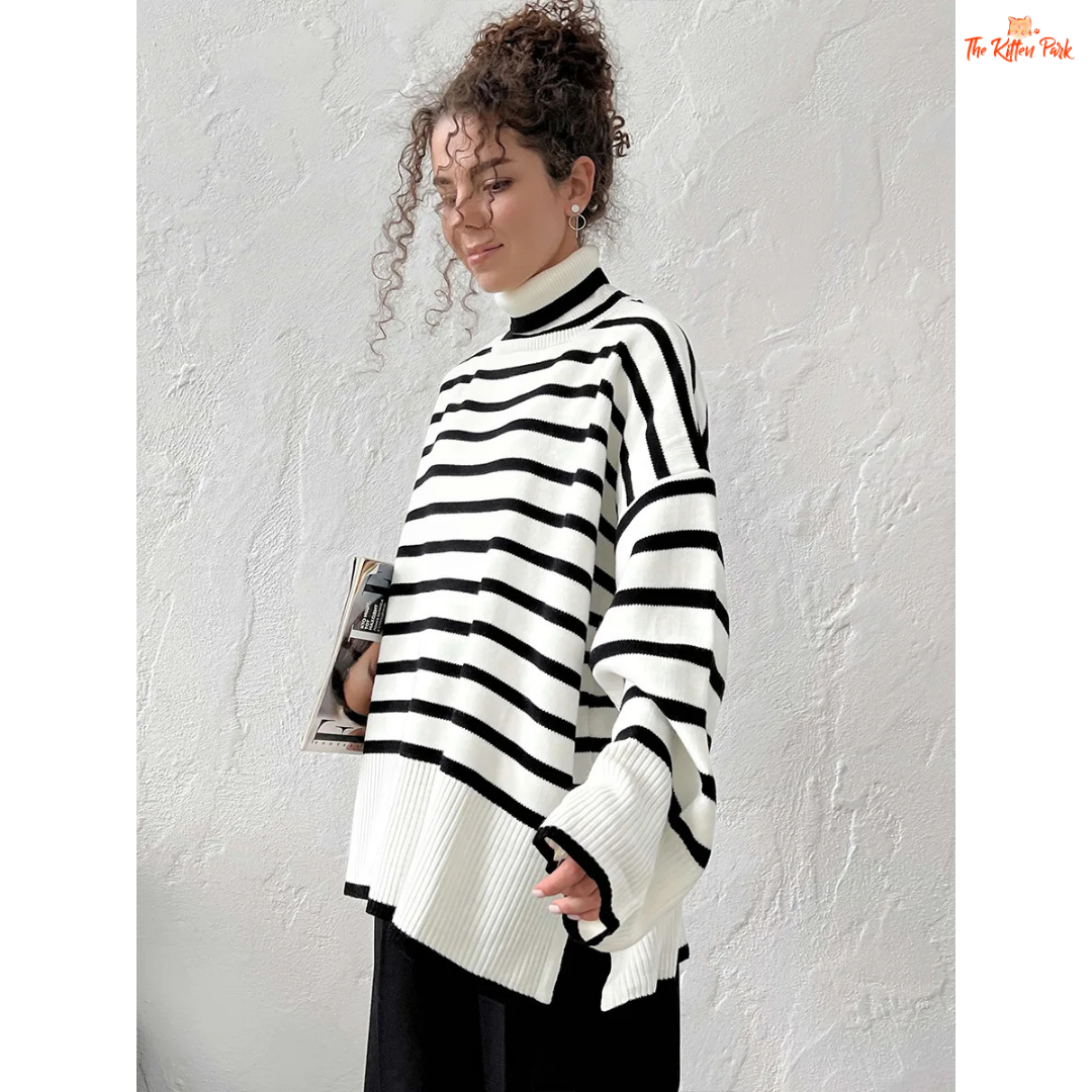 Person wearing a black and white striped sweater against a plain background