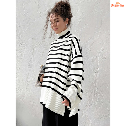 Person wearing a black and white striped sweater against a plain background