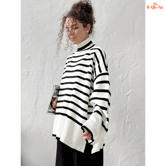 Person wearing a black and white striped sweater against a plain background