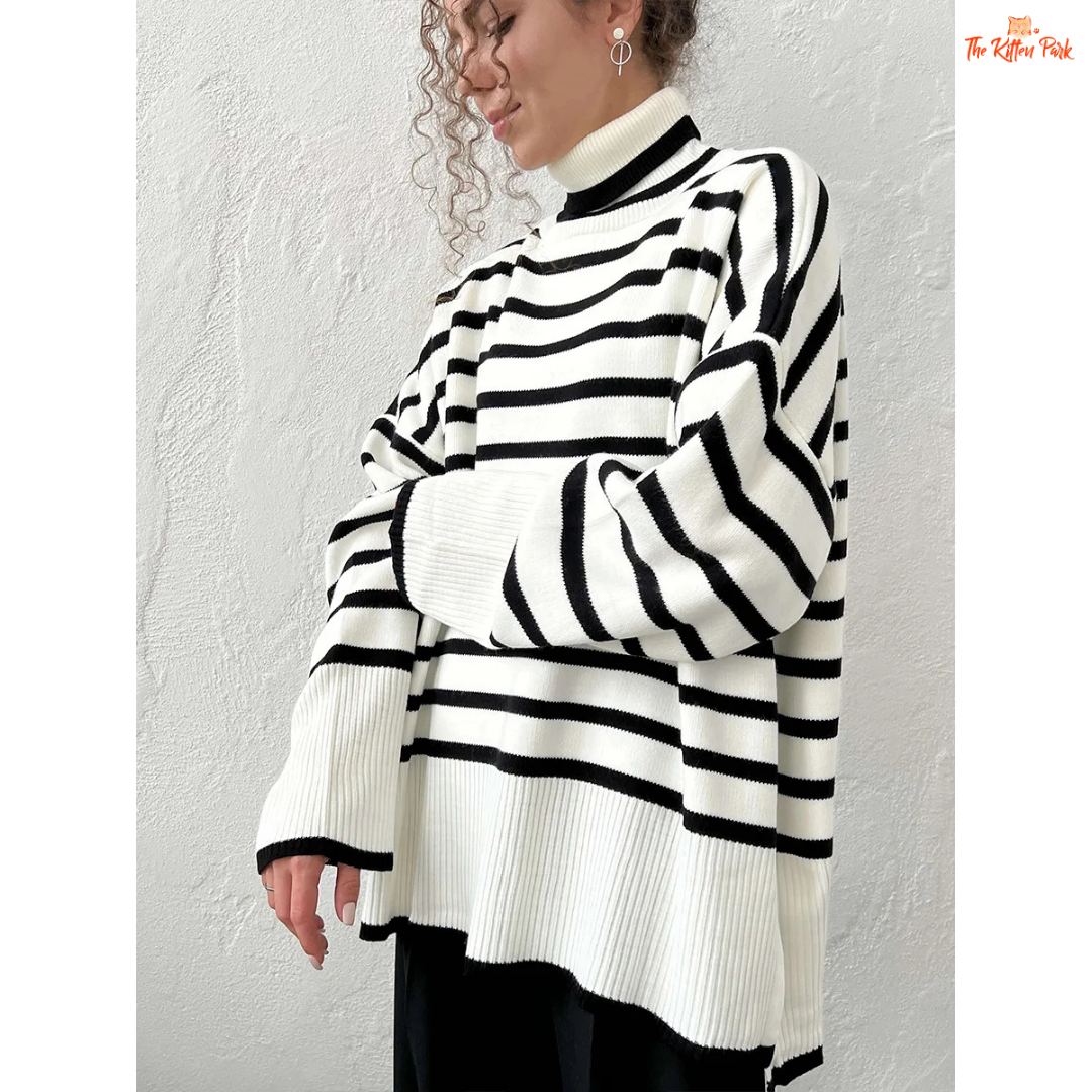 Person wearing a black and white striped sweater against a plain background