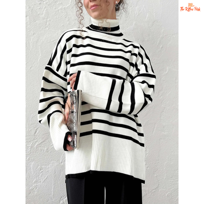 Person wearing a black and white striped sweater against a plain background