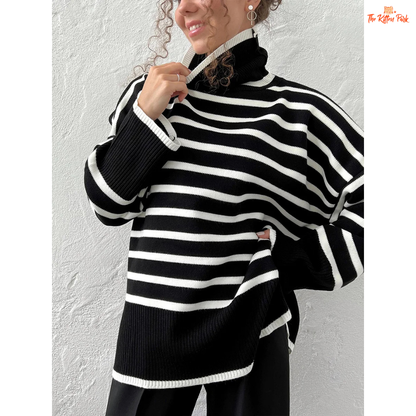 Person wearing a black and white striped sweater against a plain background