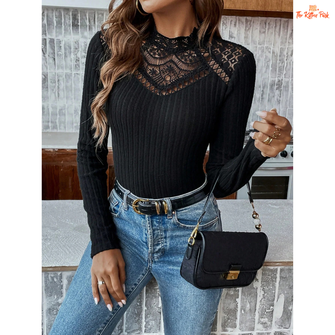 Woman wearing a black ribbed sweater with lace details and blue jeans, holding a black handbag.
