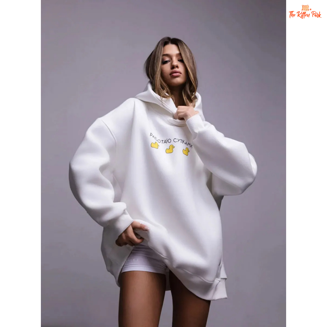 A women’s oversized fleece hoodie with a playful three-duck print, hooded collar, and drop shoulders, designed for autumn and winter casual wear.