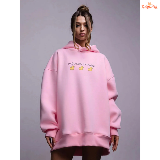 A women’s oversized fleece hoodie with a playful three-duck print, hooded collar, and drop shoulders, designed for autumn and winter casual wear.