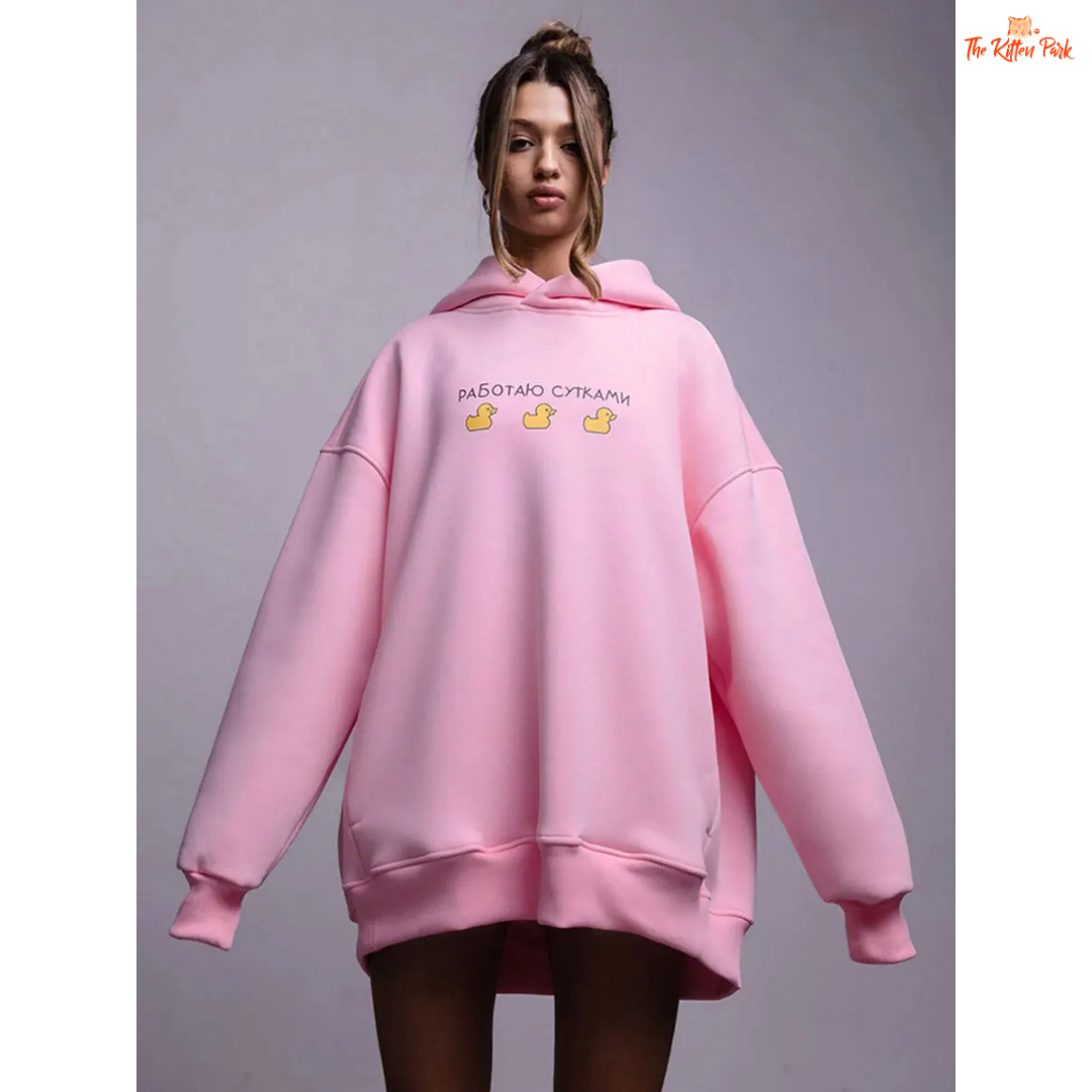A women’s oversized fleece hoodie with a playful three-duck print, hooded collar, and drop shoulders, designed for autumn and winter casual wear.