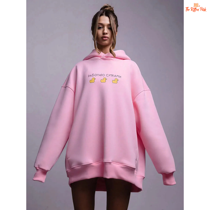 A women’s oversized fleece hoodie with a playful three-duck print, hooded collar, and drop shoulders, designed for autumn and winter casual wear.