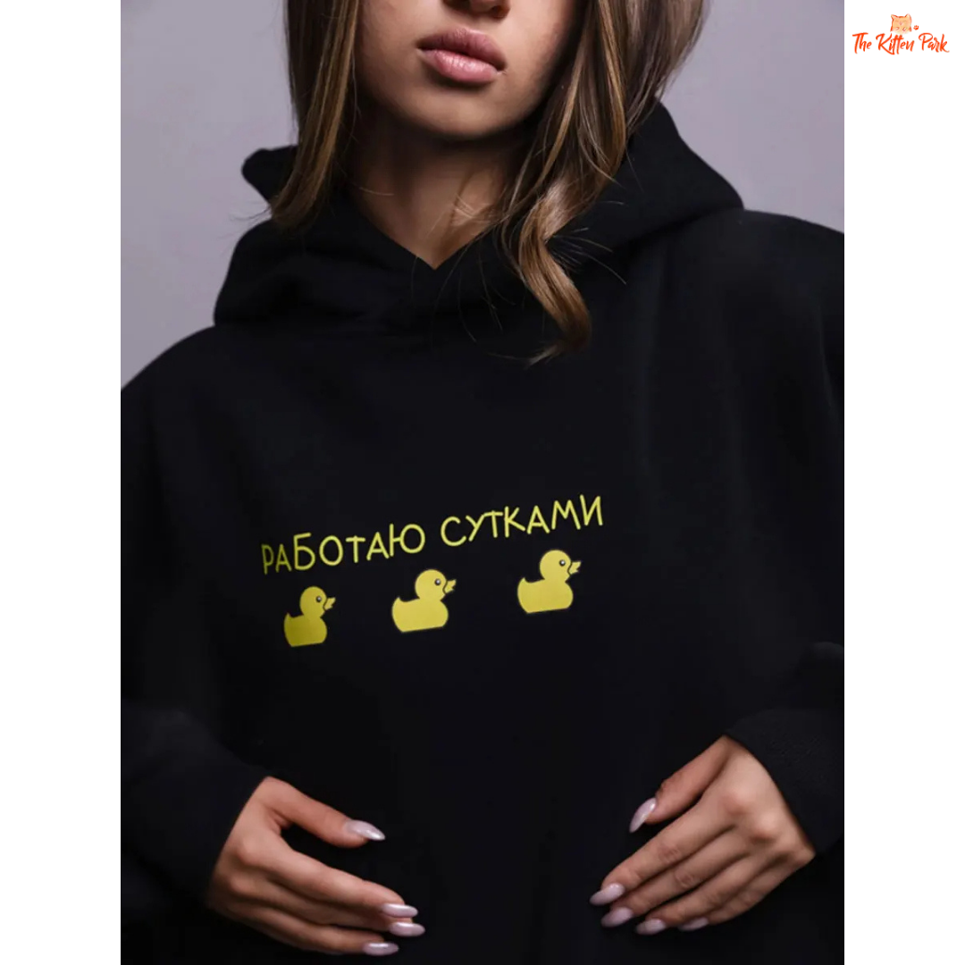 A women’s oversized fleece hoodie with a playful three-duck print, hooded collar, and drop shoulders, designed for autumn and winter casual wear.
