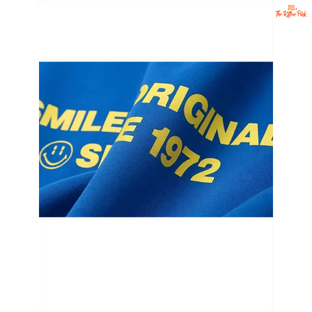Blue fabric with yellow text and smiley face logo on a white background