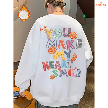A women’s cozy fleece pullover sweatshirt in off-white with the printed phrase "You Make My Heart Smile," featuring a loose fit and O-neck design.