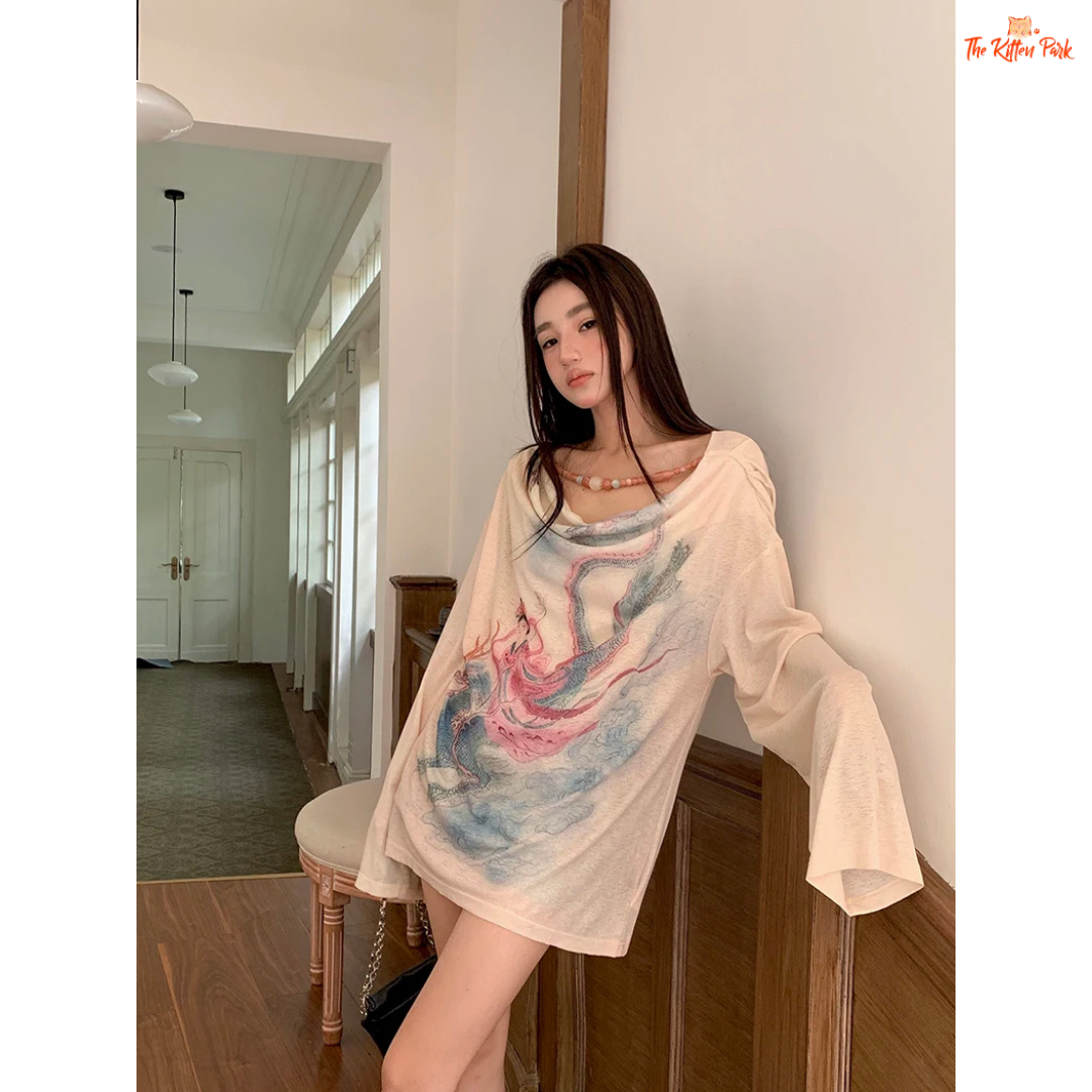 Long beige knit tee for women featuring a cowl neckline, hand-painted print, beaded accents, and a loose fit for stylish autumn layering.