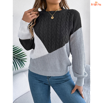 A women’s acrylic pullover sweater with color block patchwork design, O-neck, and full sleeves, crafted in heavyweight knit for autumn and winter wear.