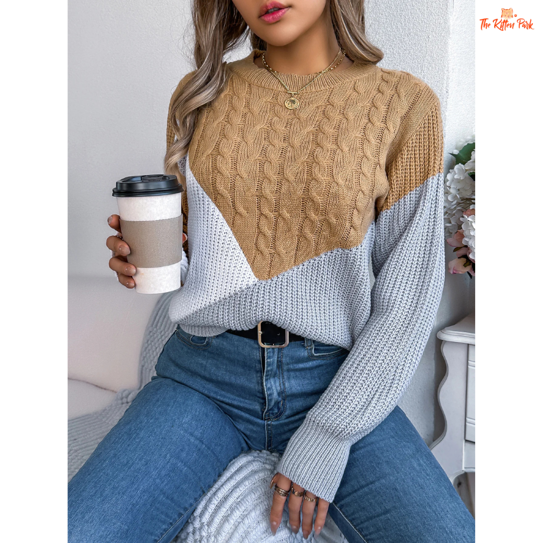 A women’s acrylic pullover sweater with color block patchwork design, O-neck, and full sleeves, crafted in heavyweight knit for autumn and winter wear.