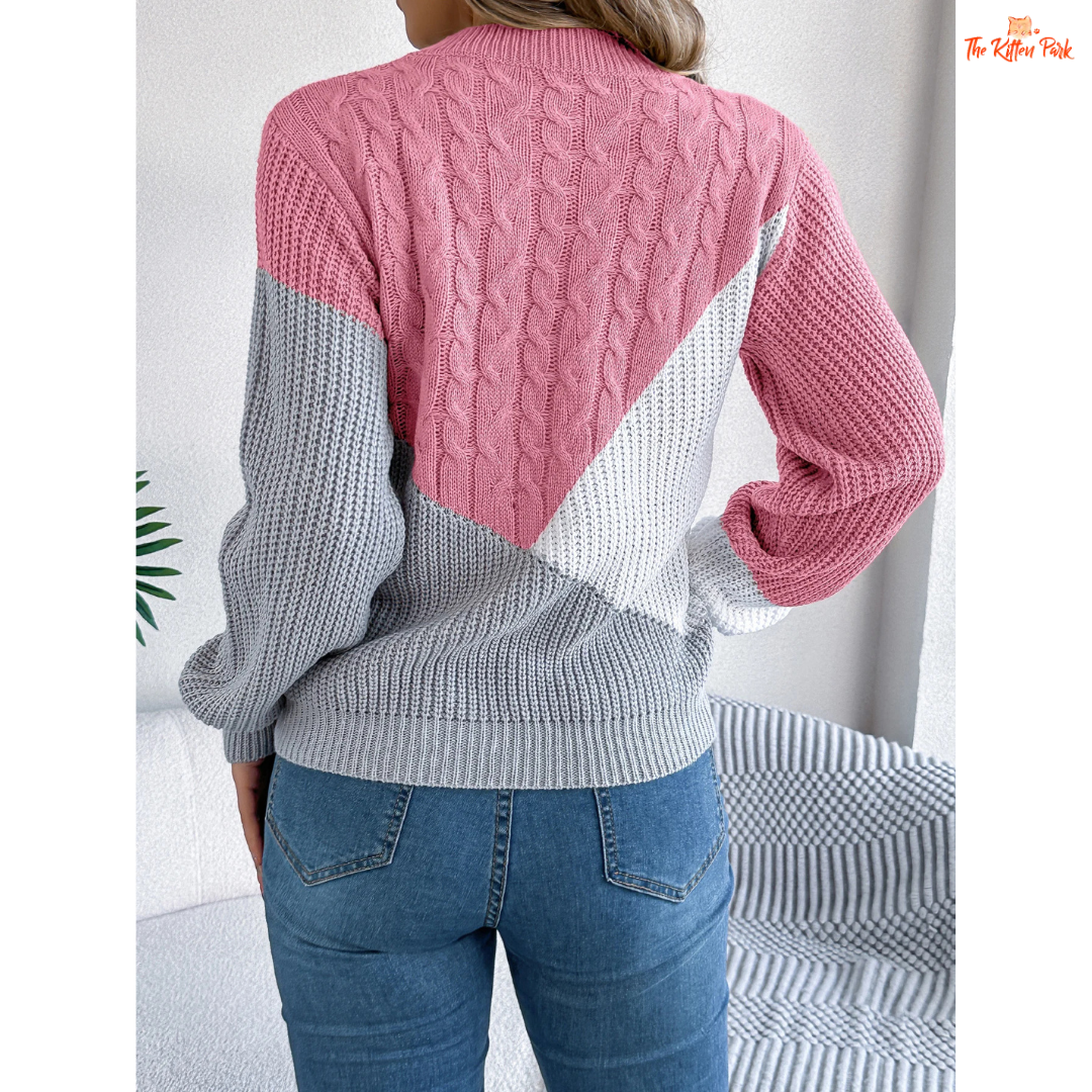 A women’s acrylic pullover sweater with color block patchwork design, O-neck, and full sleeves, crafted in heavyweight knit for autumn and winter wear.