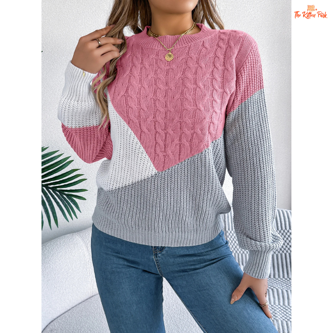 A women’s acrylic pullover sweater with color block patchwork design, O-neck, and full sleeves, crafted in heavyweight knit for autumn and winter wear.