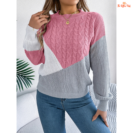 A women’s acrylic pullover sweater with color block patchwork design, O-neck, and full sleeves, crafted in heavyweight knit for autumn and winter wear.