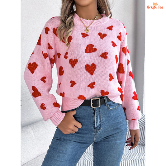 Women’s Contrast Color Heart Print Pullover Sweater featuring a soft pink background, acrylic heavyweight knit, O-neck design, and regular fit casual style for autumn and winter.