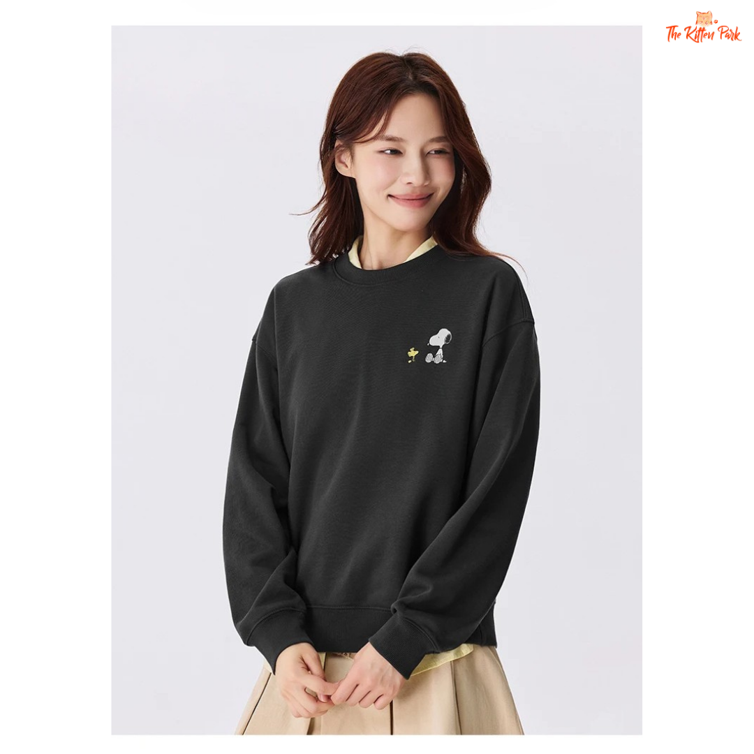 A women’s loose fit autumn sweatshirt with cartoon print, O-neck pullover design, and casual cotton-polyester blend comfort.