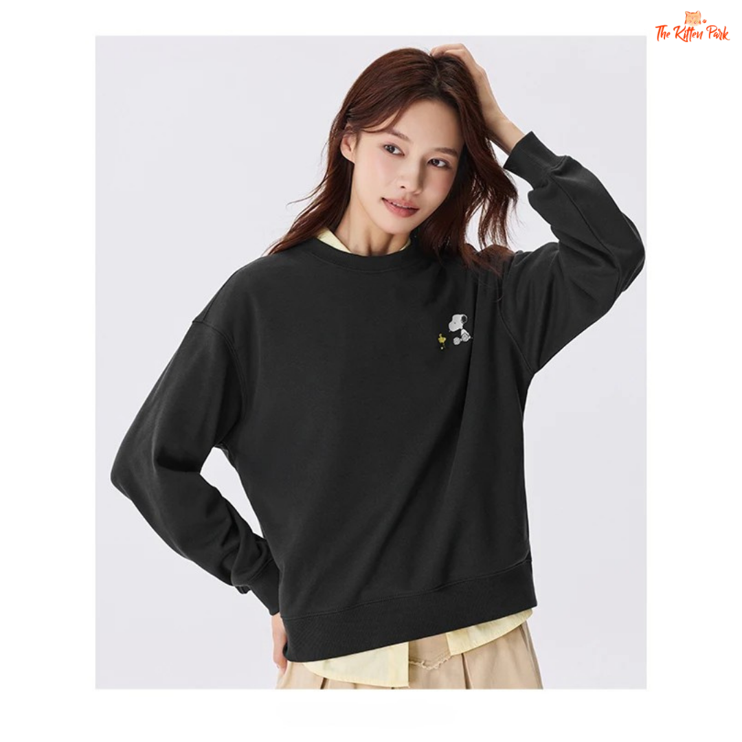 A women’s loose fit autumn sweatshirt with cartoon print, O-neck pullover design, and casual cotton-polyester blend comfort.