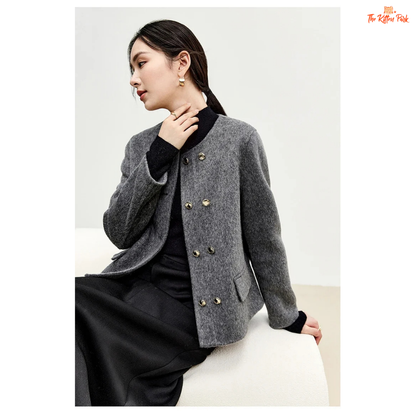 Woman wearing a gray coat with gold buttons on a white background