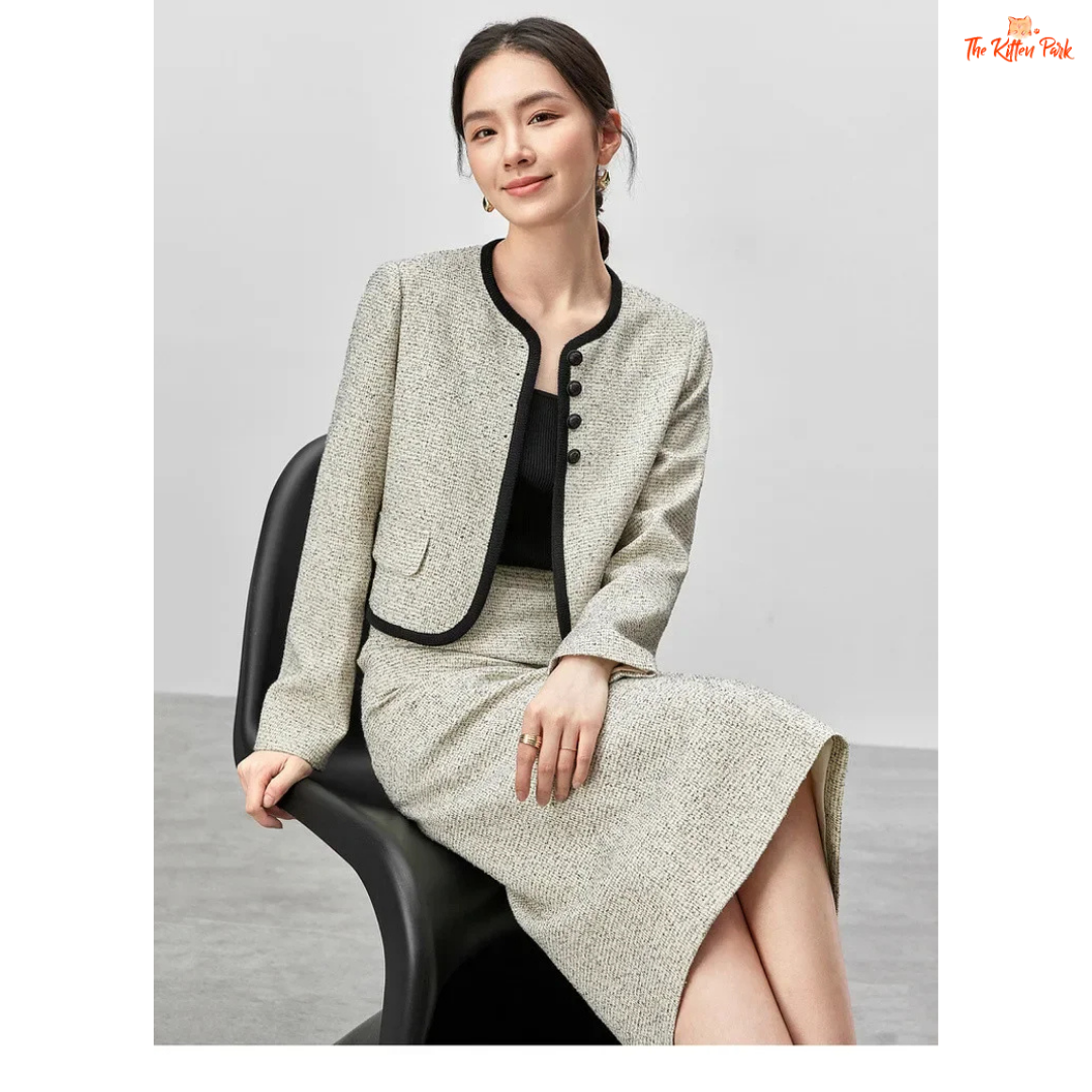 Elegant women’s tweed two-piece skirt set in off-white with contrast trim, featuring a single-breasted jacket and mid-calf skirt for autumn and winter wear.