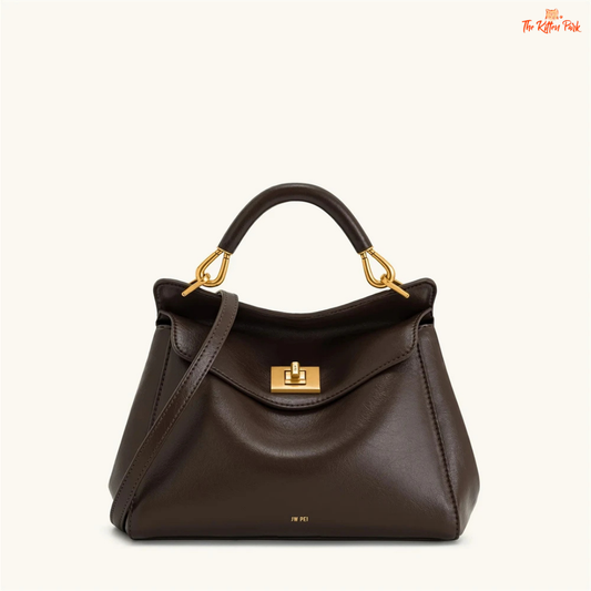 Stylish light luxury women's shoulder bag with lock closure, PU texture, baguette shape, and elegant gold chain accent in soft red and beige tones.