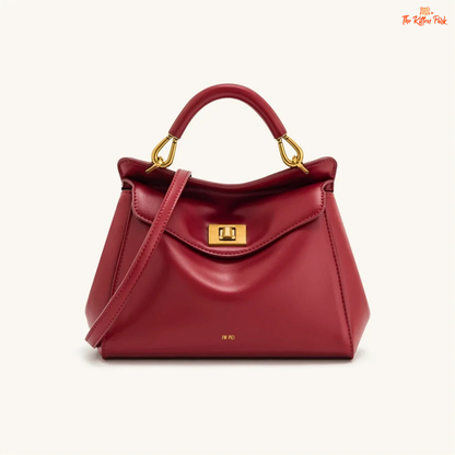 Stylish light luxury women's shoulder bag with lock closure, PU texture, baguette shape, and elegant gold chain accent in soft red and beige tones.