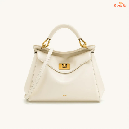 Stylish light luxury women's shoulder bag with lock closure, PU texture, baguette shape, and elegant gold chain accent in soft red and beige tones.