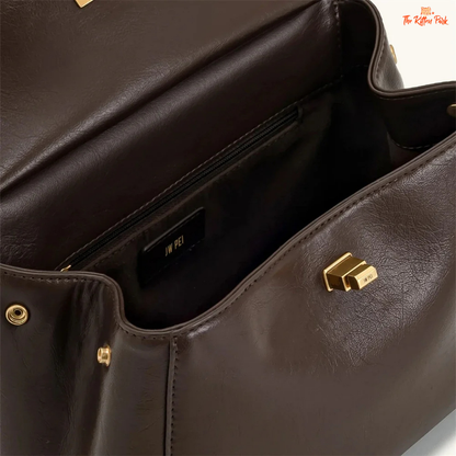 Stylish light luxury women's shoulder bag with lock closure, PU texture, baguette shape, and elegant gold chain accent in soft red and beige tones.