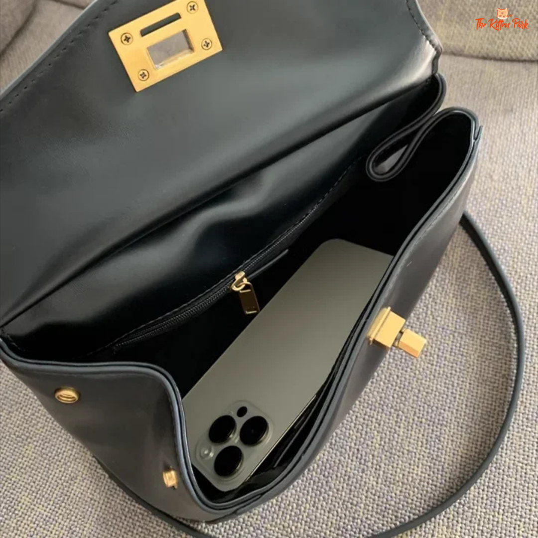 Stylish light luxury women's shoulder bag with lock closure, PU texture, baguette shape, and elegant gold chain accent in soft red and beige tones.