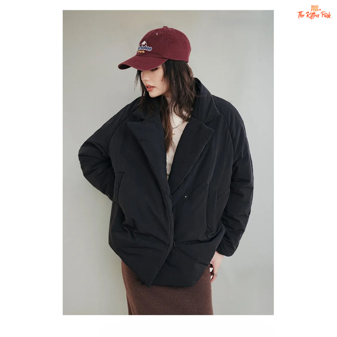 A black cotton-padded puffer coat for women with a collared design, thick warmth, covered button full opening, polyester fiber filling, and regular loose streetwear fit.